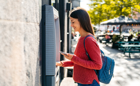 woman using an outdoor ATM
