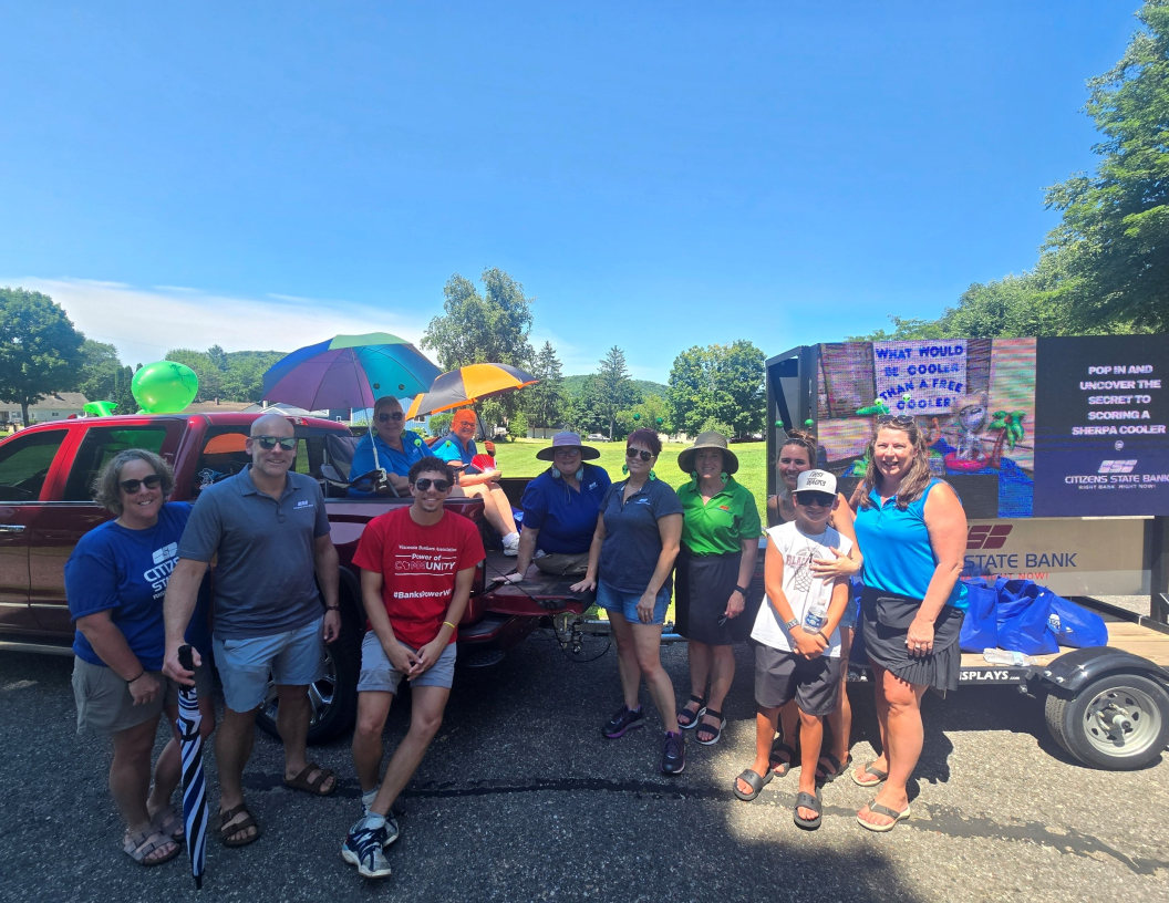 A group of employees getting ready to march in a parade.
